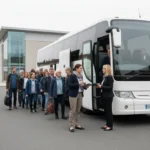Group boarding an unbranded UK coach for a day hire trip while an organiser checks details